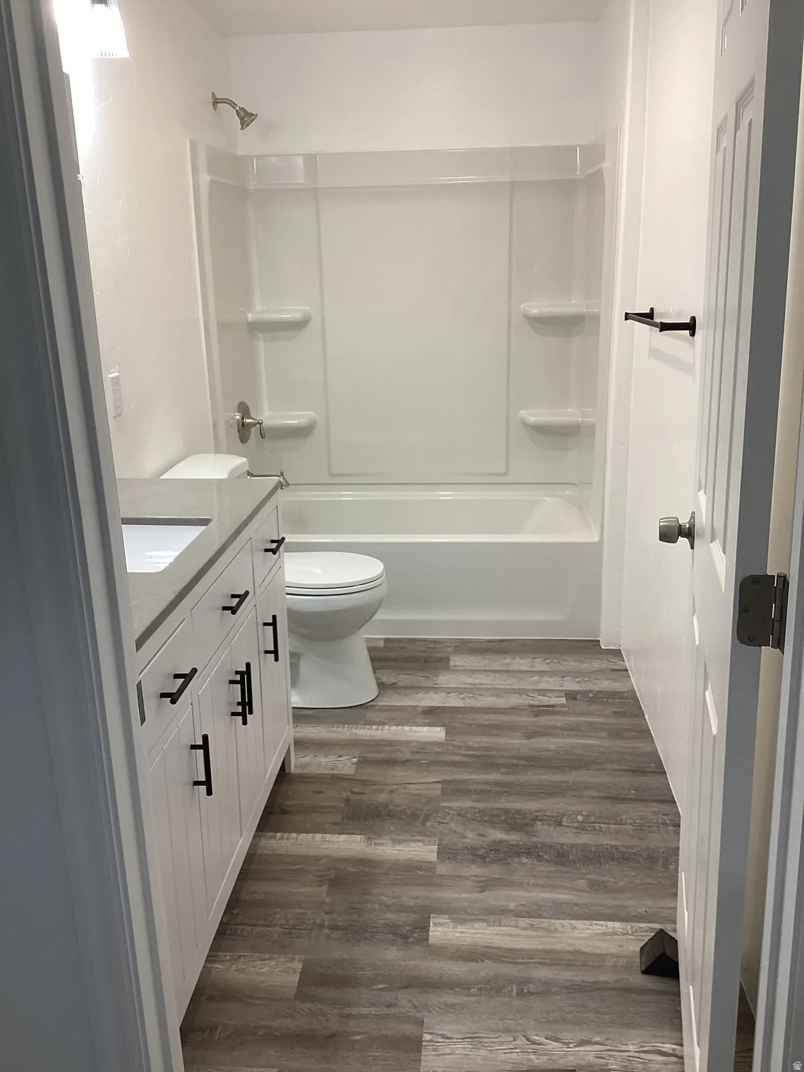 Full bath featuring vanity, dark wood-style floors, and bathing tub / shower combination