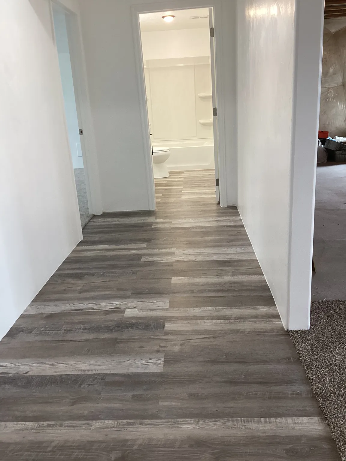 Hallway featuring dark wood-style floors