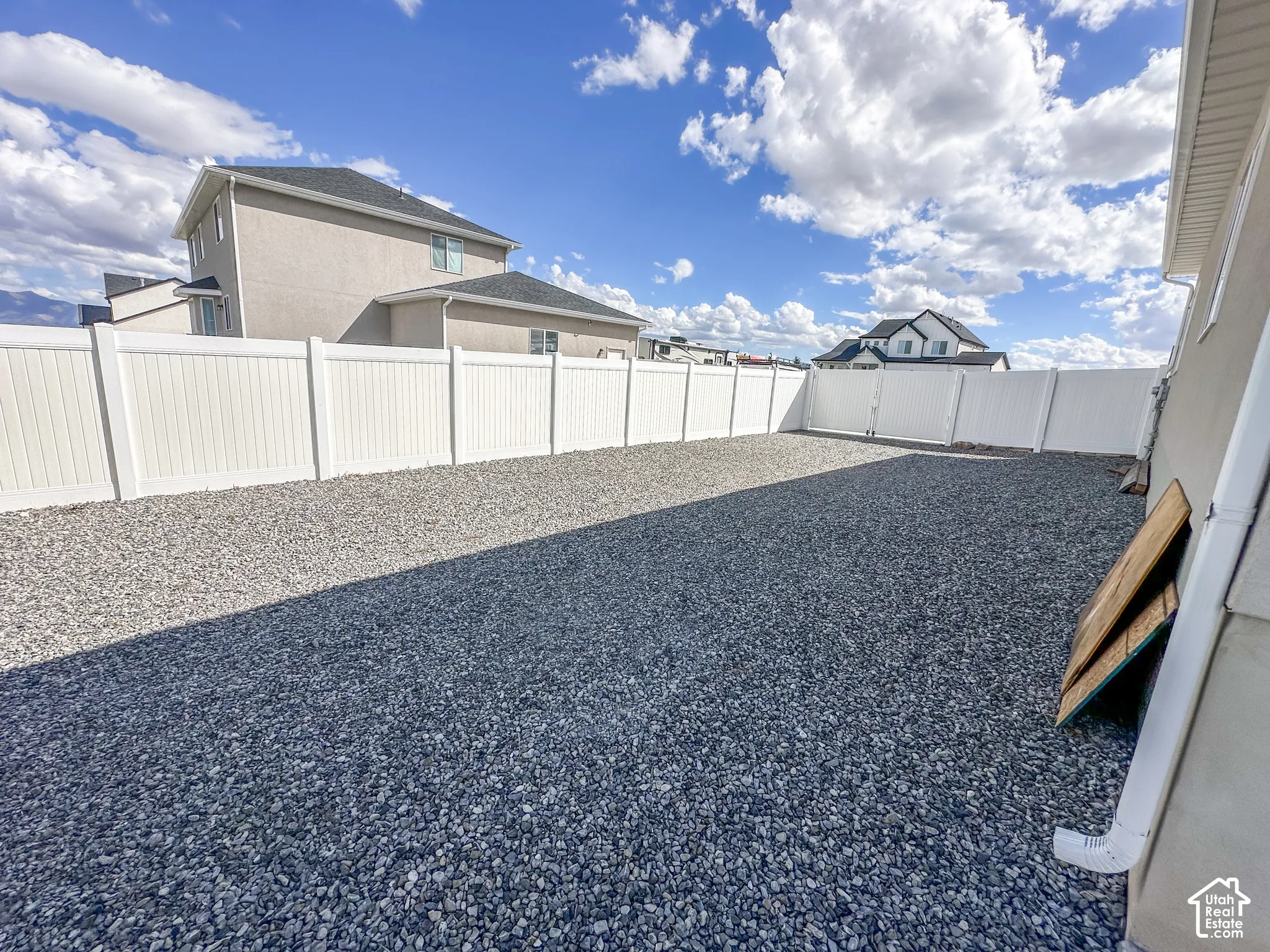 Fenced yard featuring a gravel surface