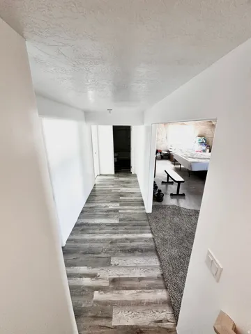 Wood-finish flooring throughout the hallway