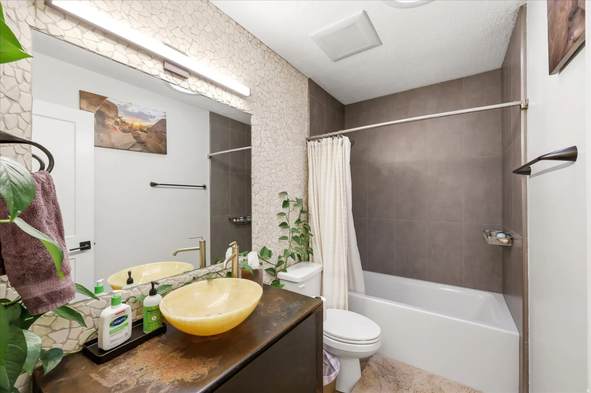 Bathroom featuring vanity and shower / bath combo with shower curtain