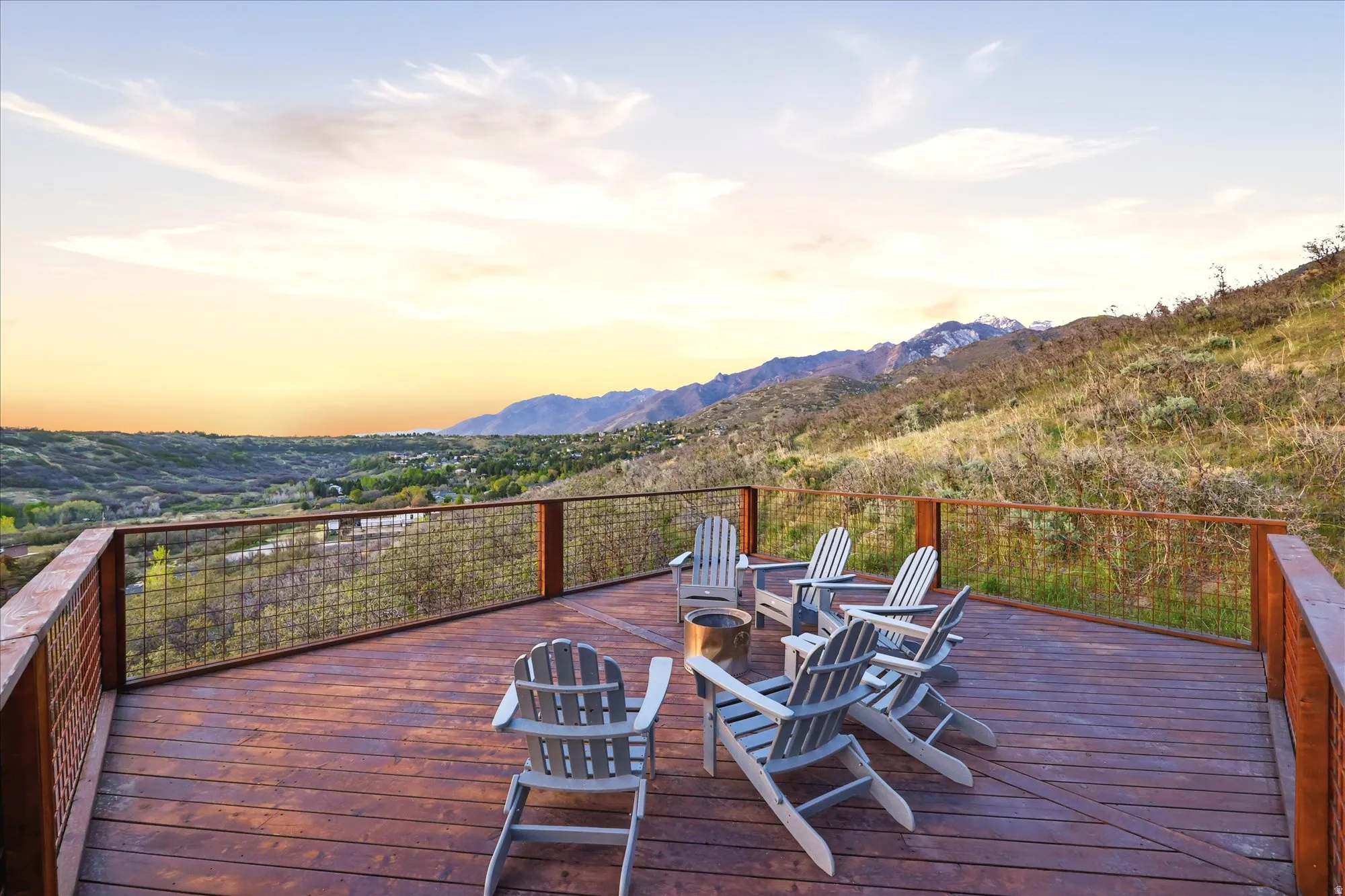 Deck at dusk featuring an outdoor fire pit and a mountain view