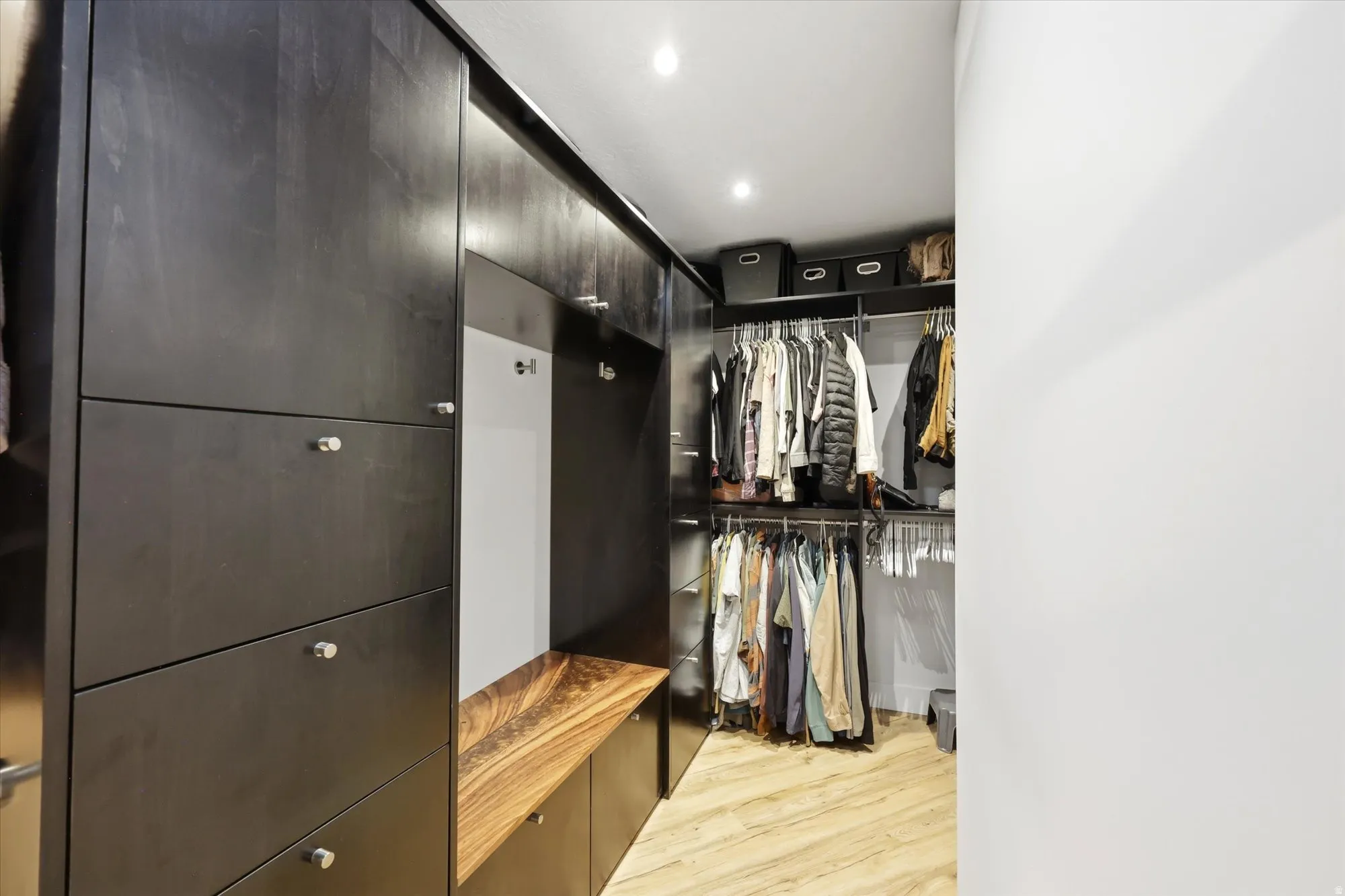 Walk in closet featuring light wood-style flooring
