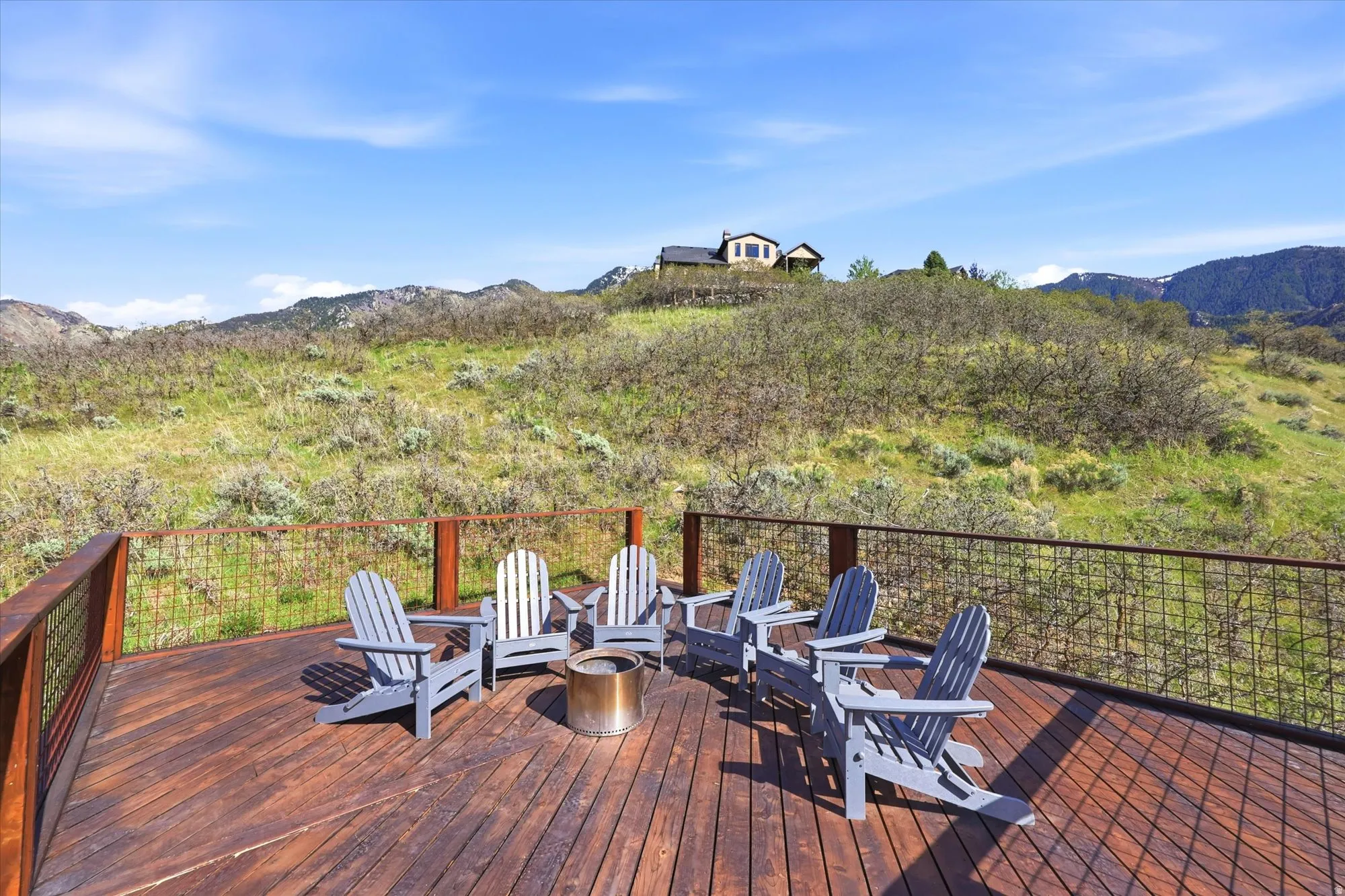 Wooden terrace with a mountain view and an outdoor fire pit