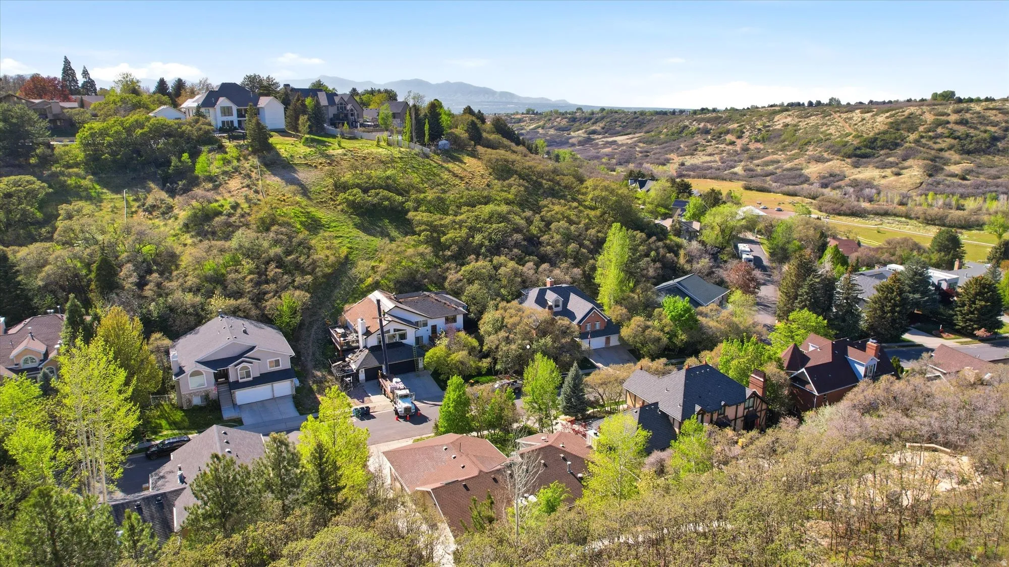 Aerial perspective of suburban area featuring a mountainous background