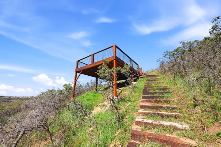 View of property's community featuring stairway and a deck