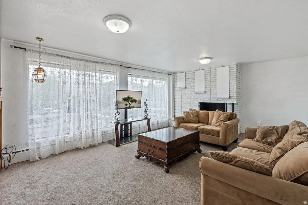 Living room with carpet and a textured ceiling