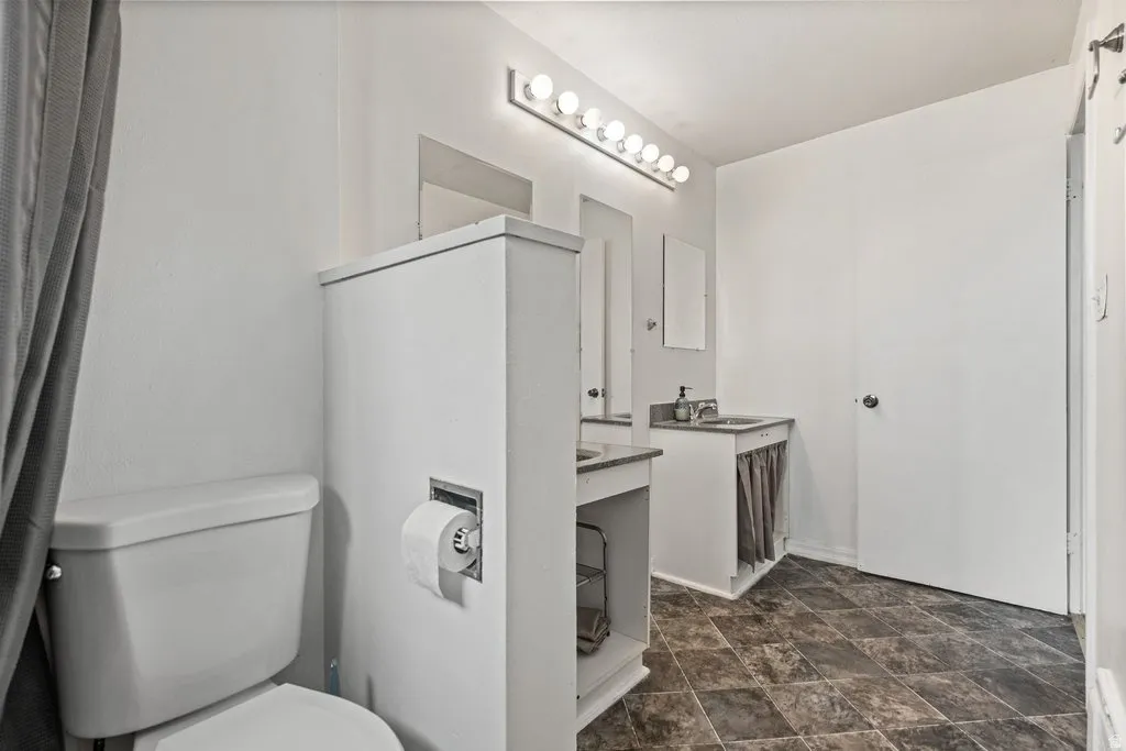 Bathroom featuring vanity and stone finish floors