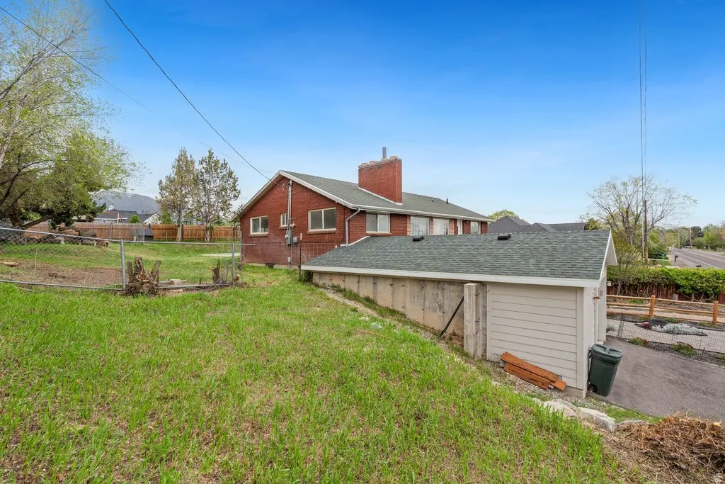 View of side of home with a fenced backyard