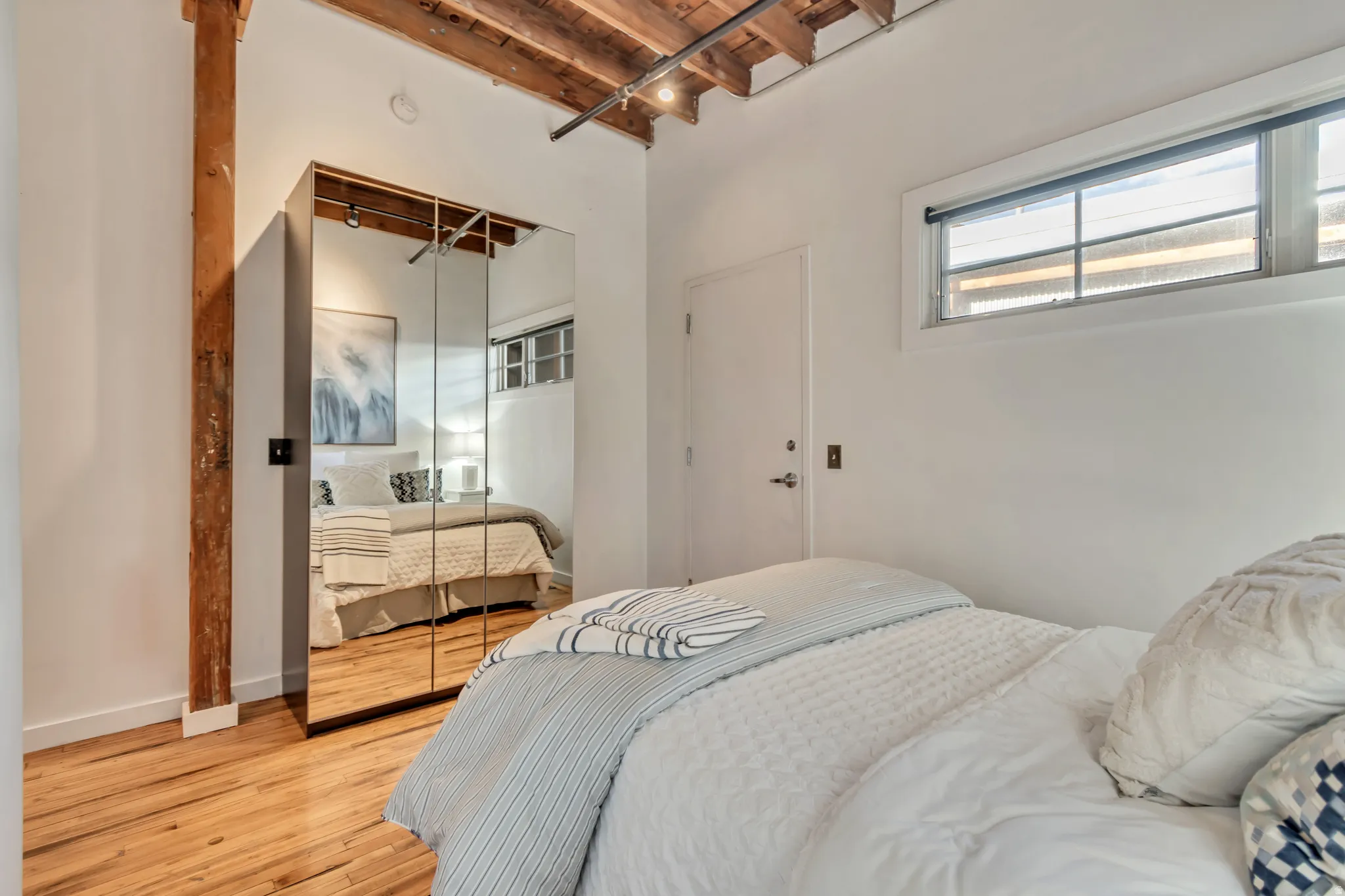Bedroom with light wood-style floors and a closet
