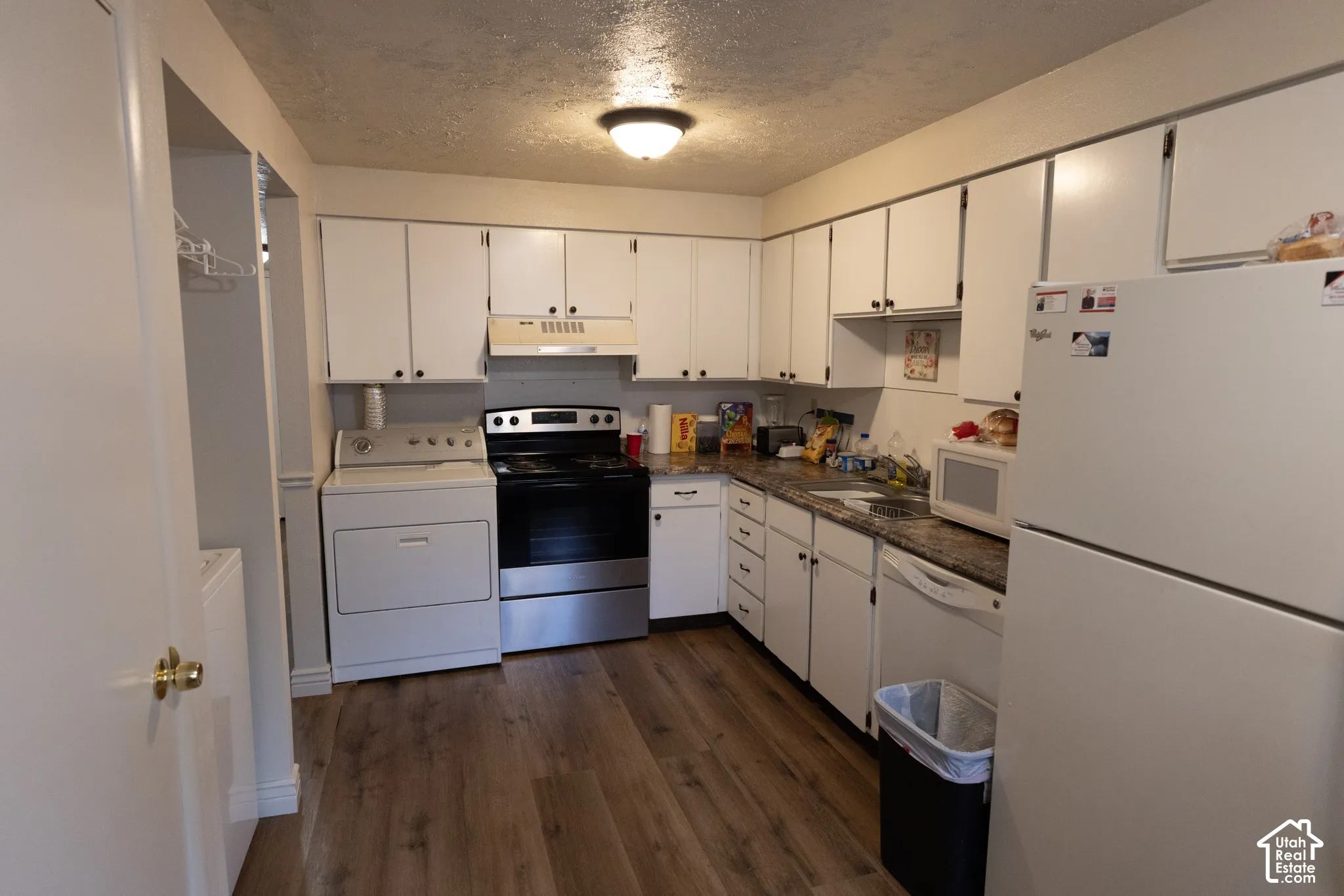 Kitchen featuring  dark countertops, wood-type flooring