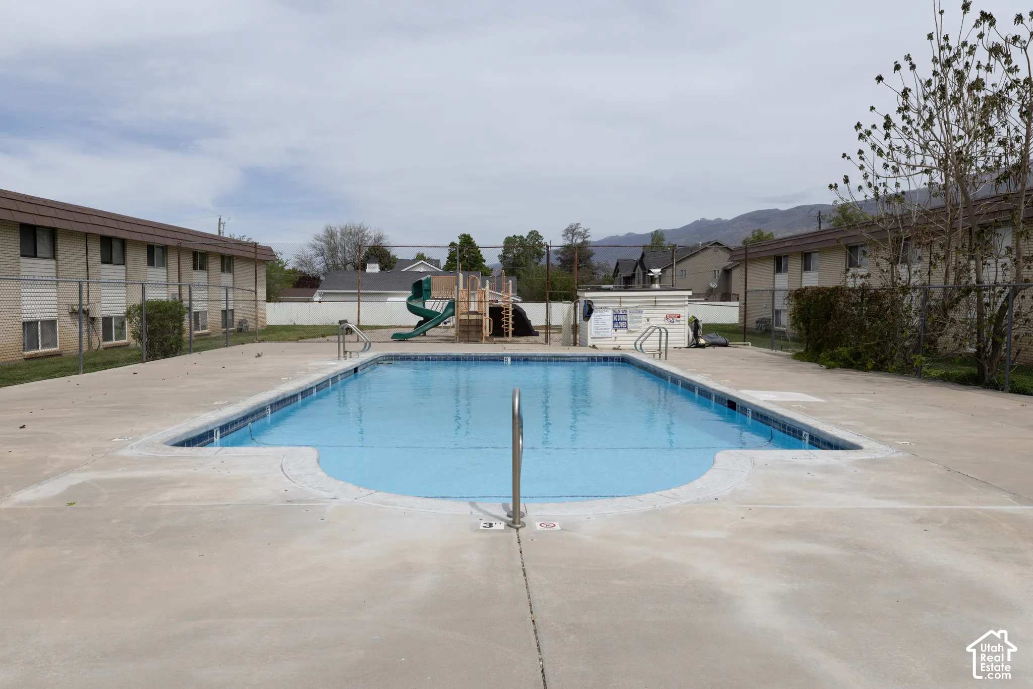 Community pool featuring a patio and a residential view
