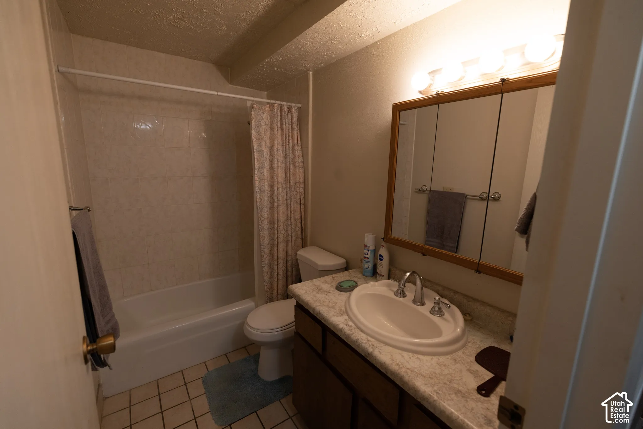 Bathroom featuring vanity, shower / tub combo.