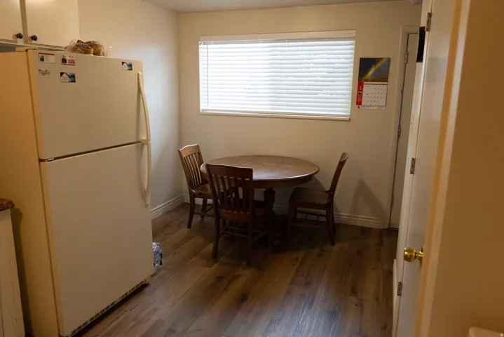 Dining area featuring dark wood-type flooring