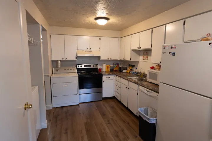Kitchen featuring  dark countertops, wood-type flooring