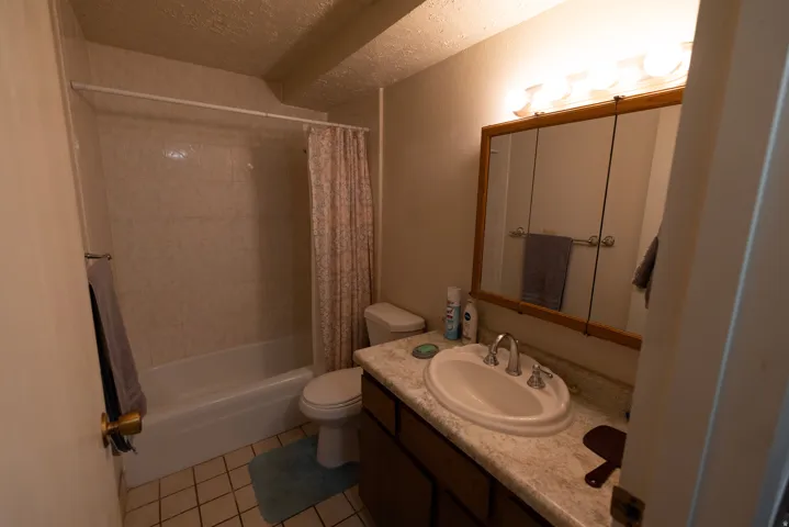 Bathroom featuring vanity, shower / tub combo.
