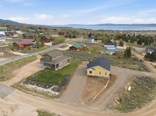 Aerial view of property's location featuring mountains and nearby suburban area