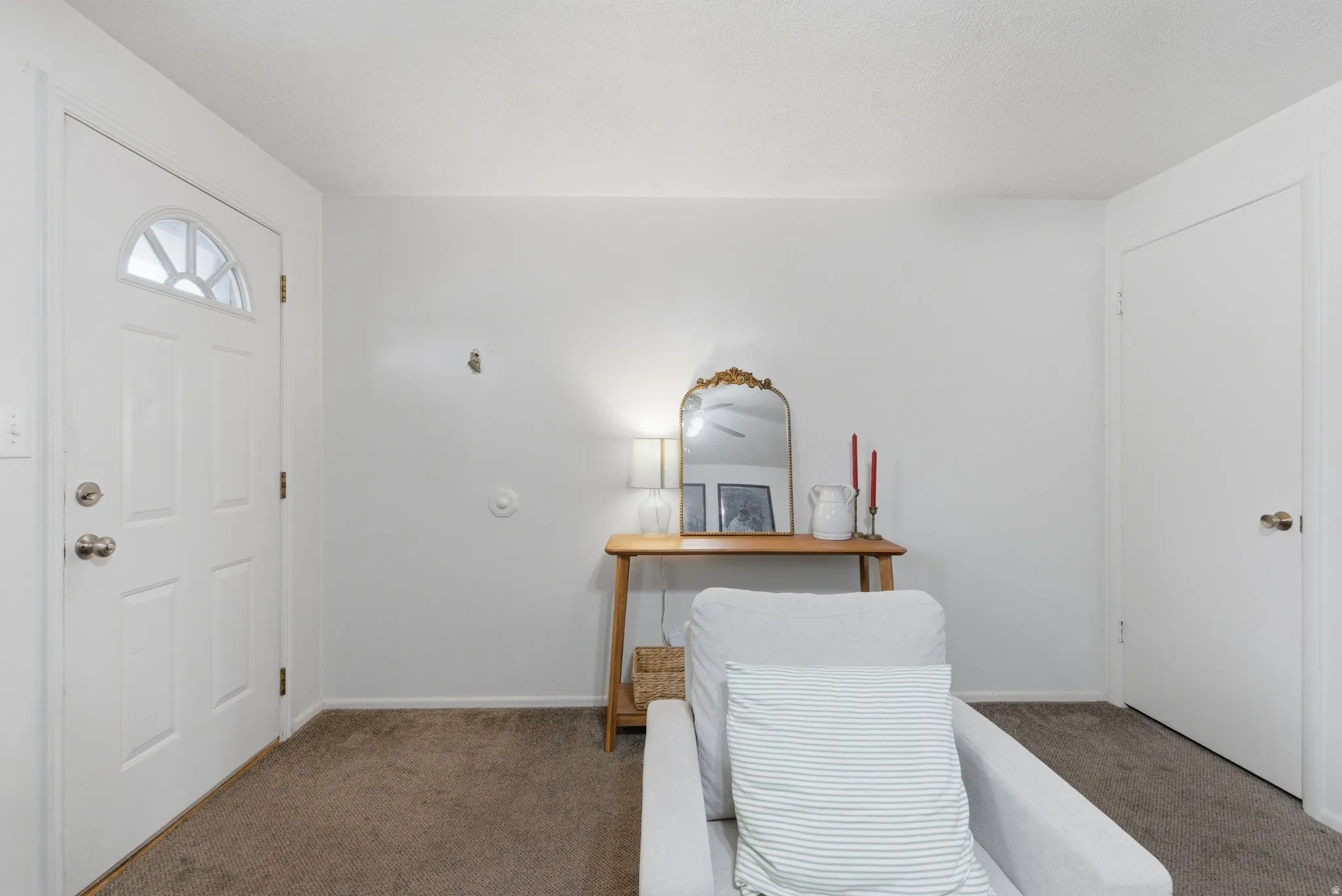 Carpeted home office featuring baseboards