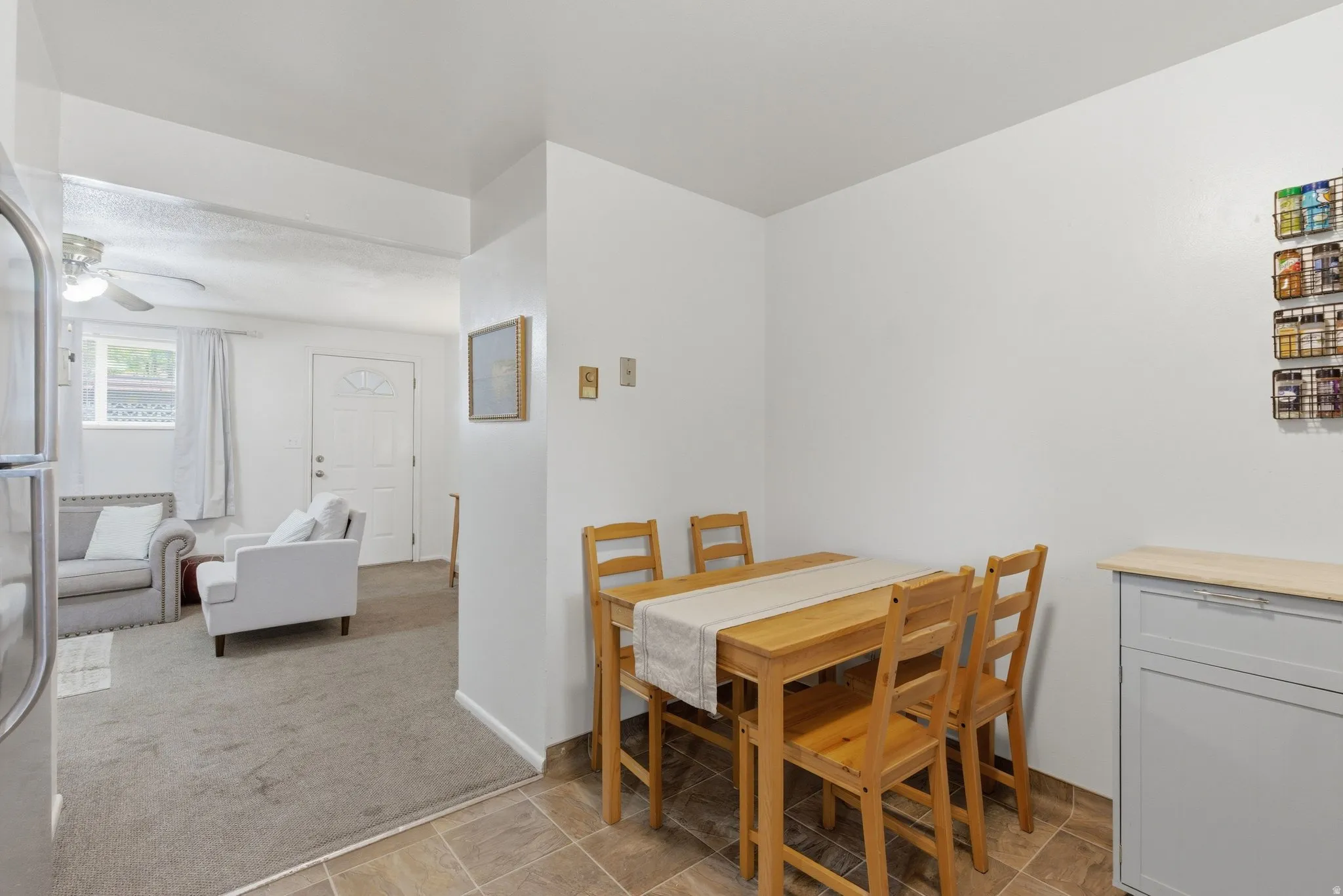 Dining space featuring light carpet and ceiling fan