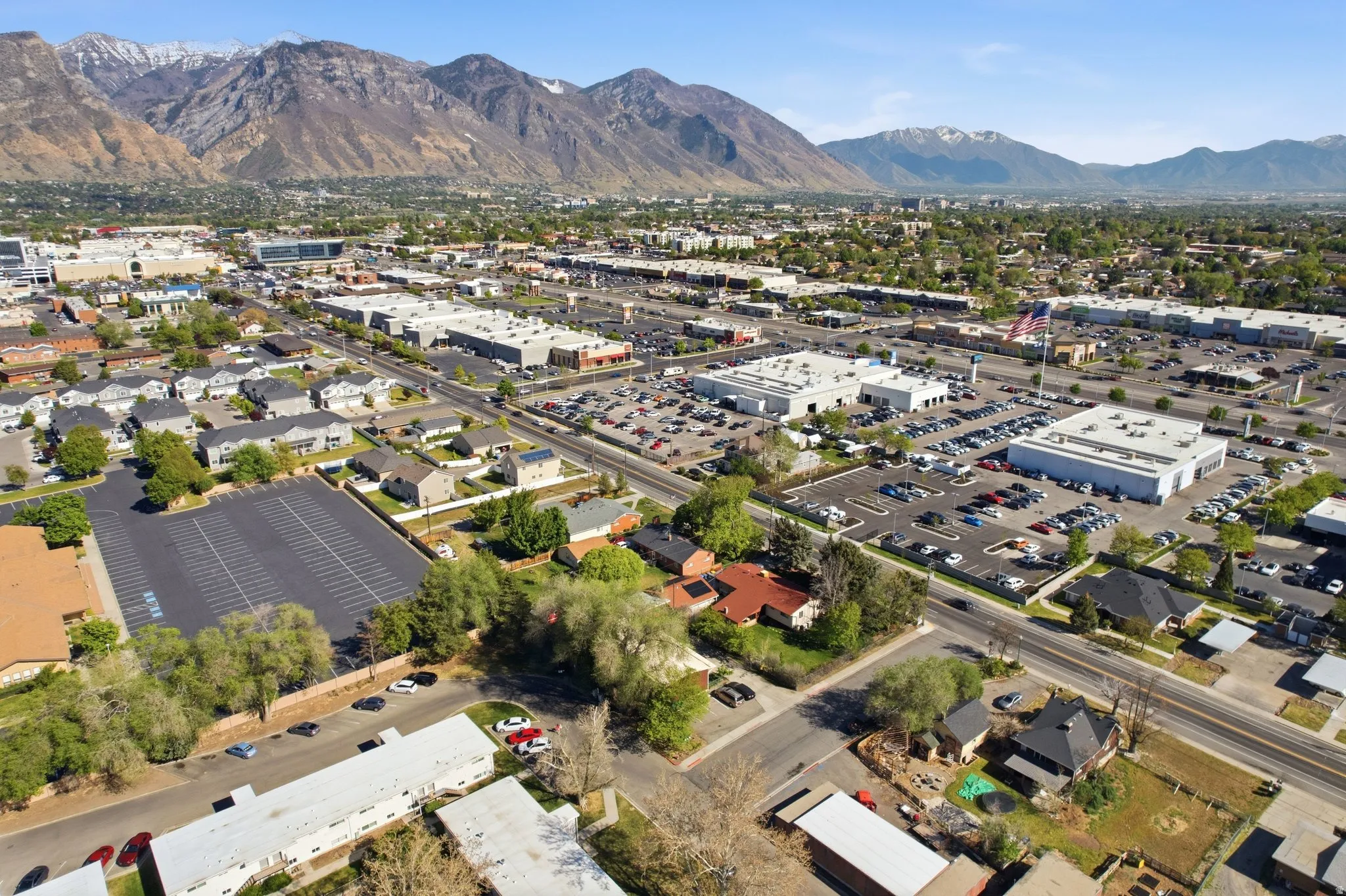 Aerial overview of property's location featuring a mountainous background and a commercial area