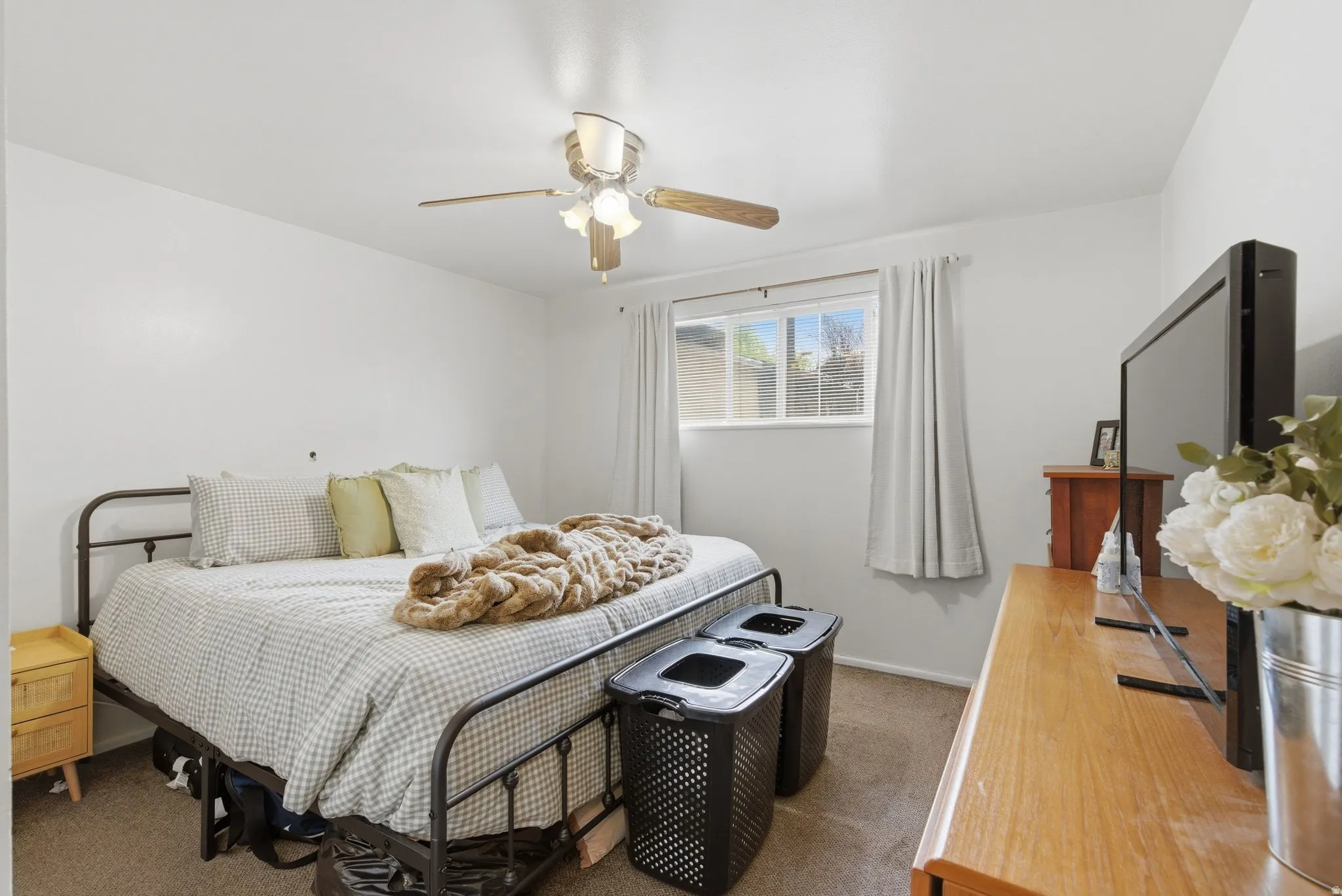 Bedroom featuring dark carpet and ceiling fan