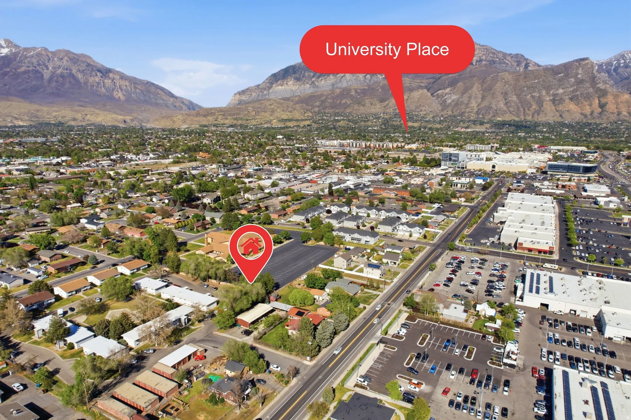 Aerial view of property's location featuring a mountain backdrop
