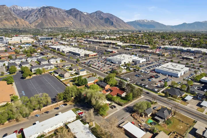 Aerial overview of property's location featuring a mountainous background and a commercial area