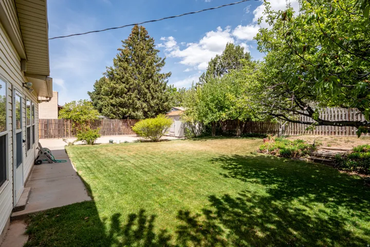 Fenced backyard with a patio