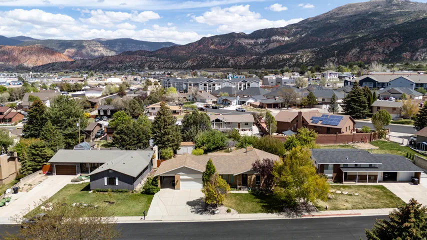 Aerial perspective of suburban area featuring a mountain backdrop