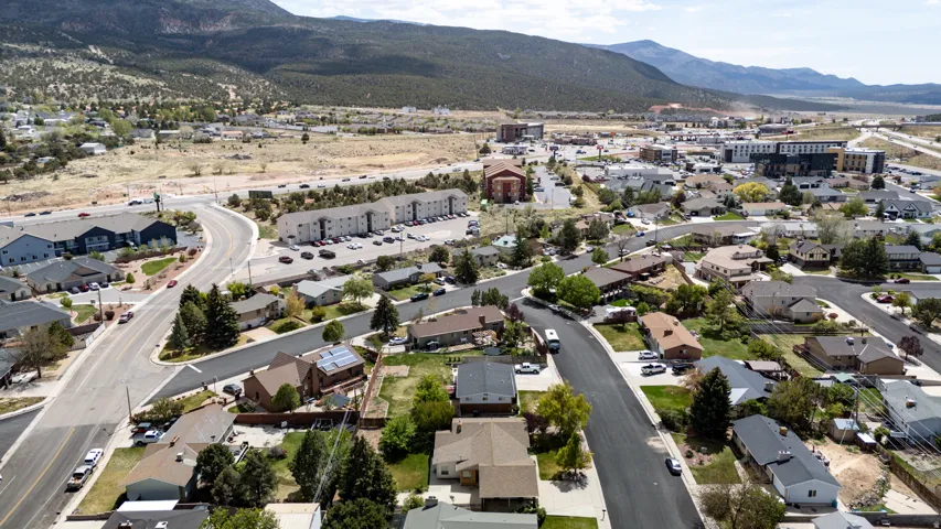 Aerial overview of property's location featuring nearby suburban area and a mountainous background