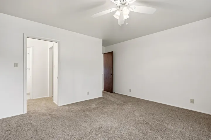Unfurnished bedroom featuring carpet and ceiling fan