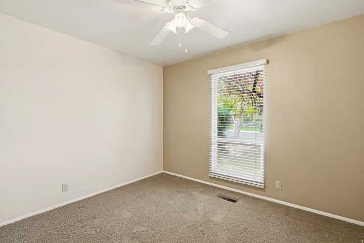 Unfurnished room with carpet floors and ceiling fan