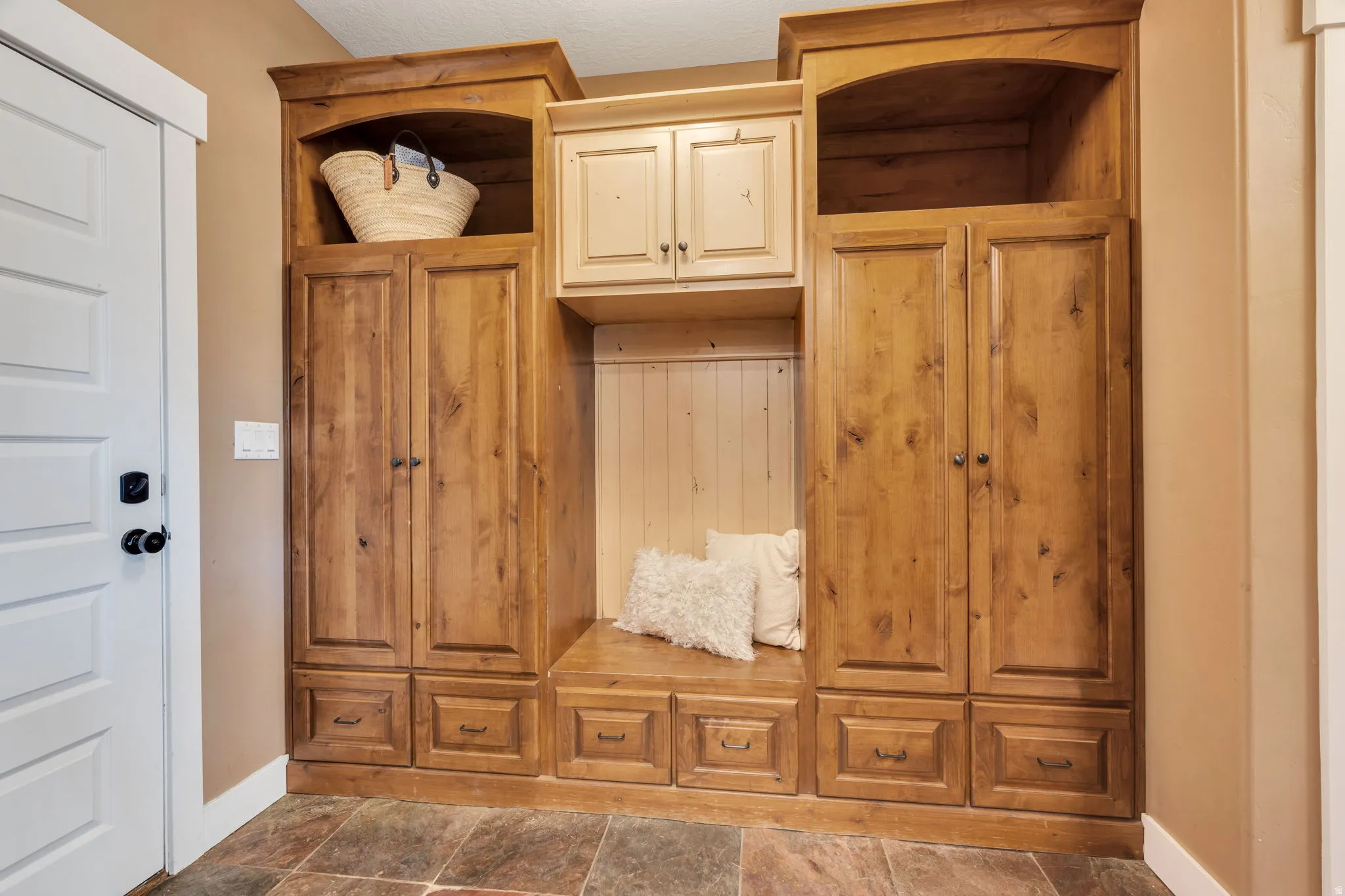 Built-in wood-finish cabinetry featuring storage compartments, drawers, and an integrated bench seating area