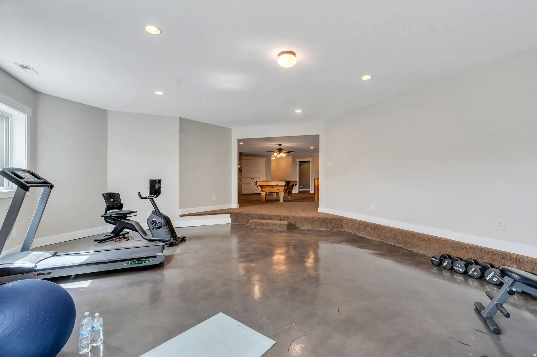 Exercise area with recessed lighting and ceiling fan