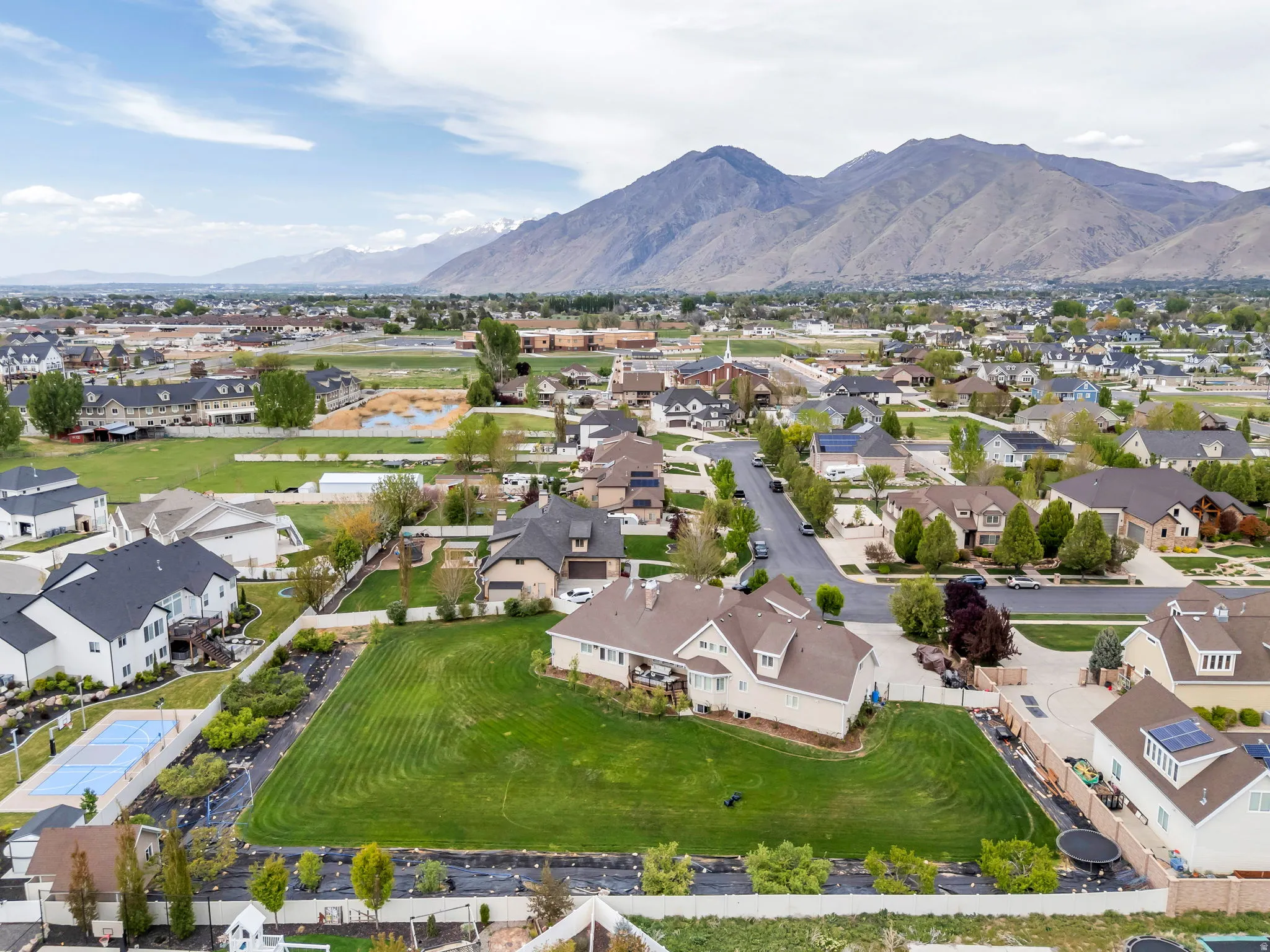 Aerial perspective of suburban area with a mountainous background