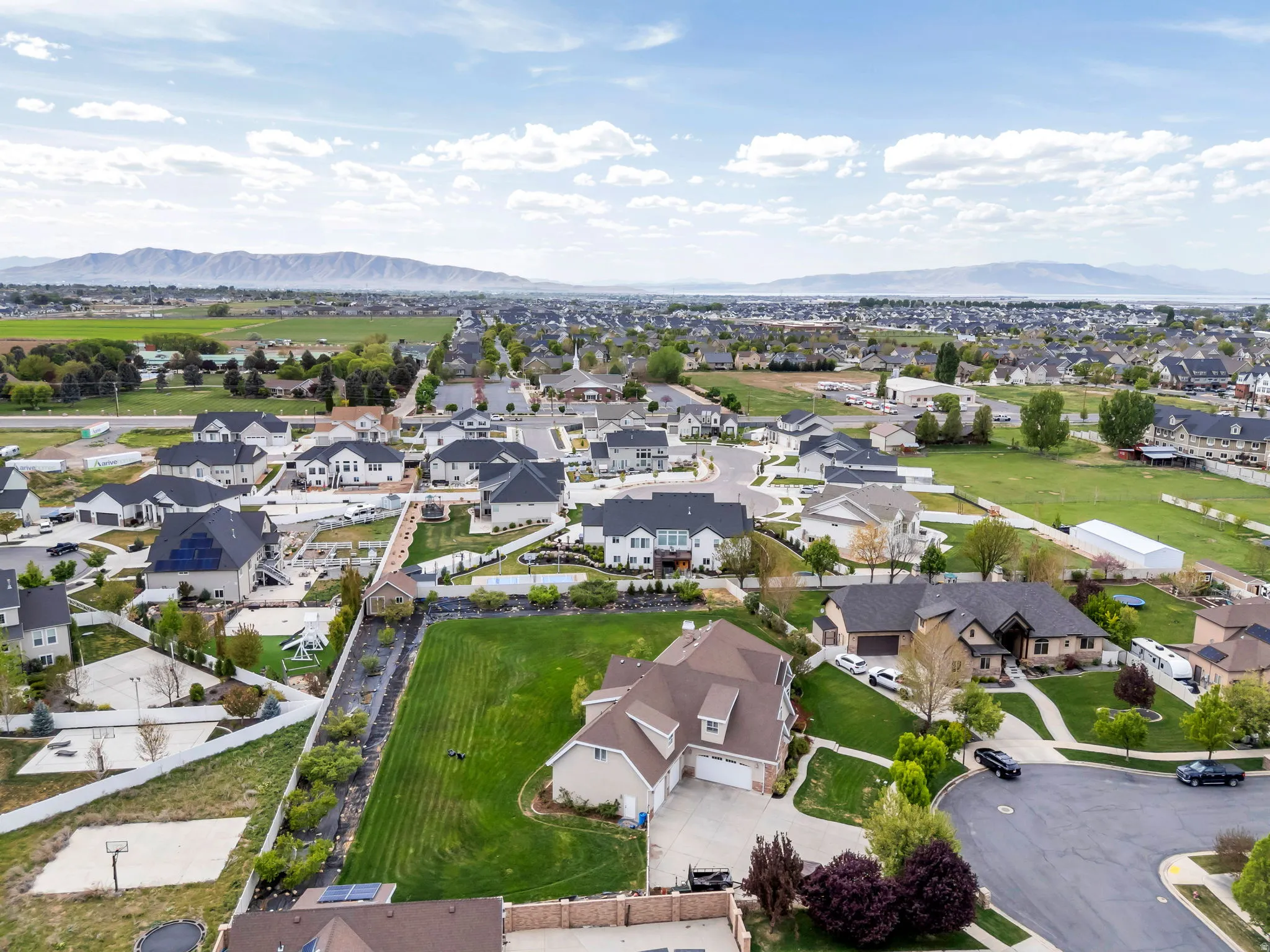 Aerial view of property and surrounding area with nearby suburban area