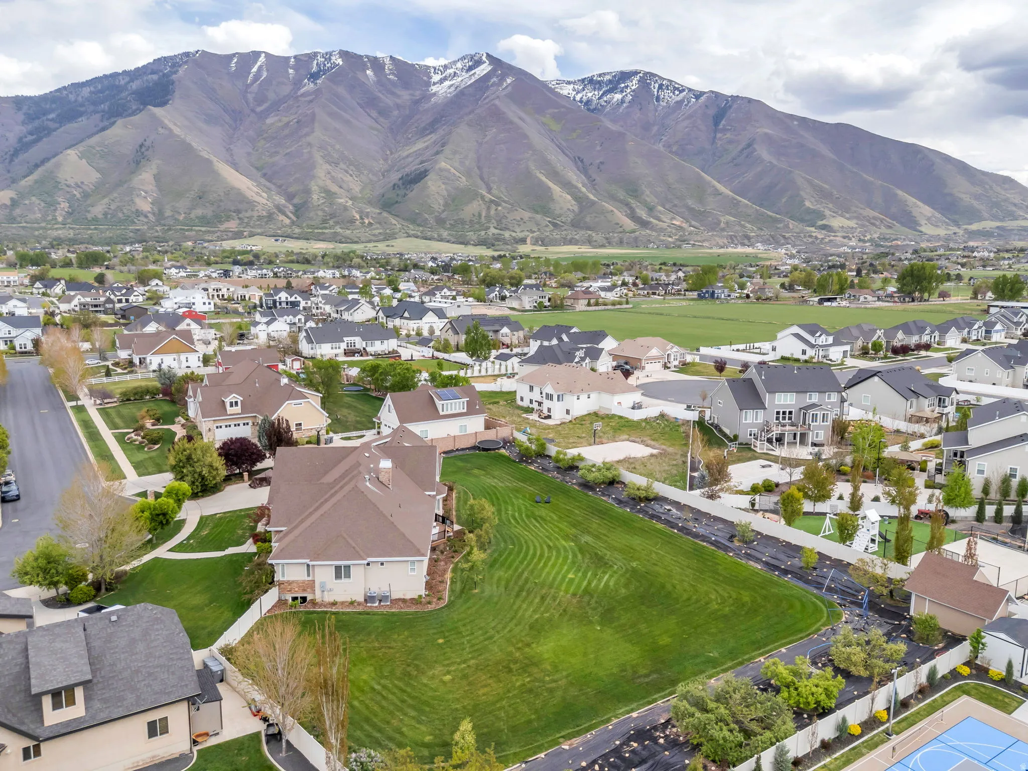 Aerial view of property's location featuring nearby suburban area and a mountain backdrop