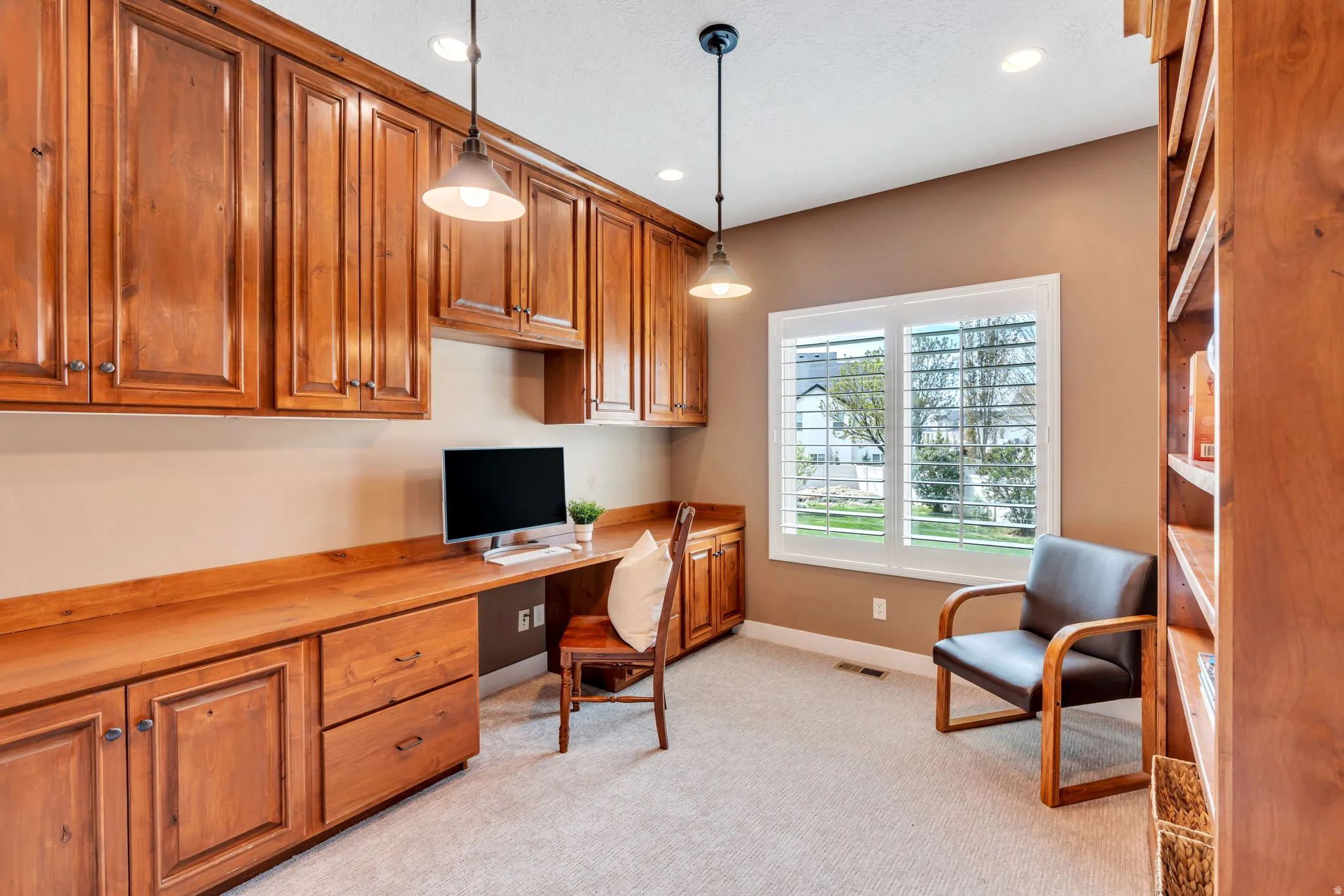 Office featuring built in study area, recessed lighting, and light carpet