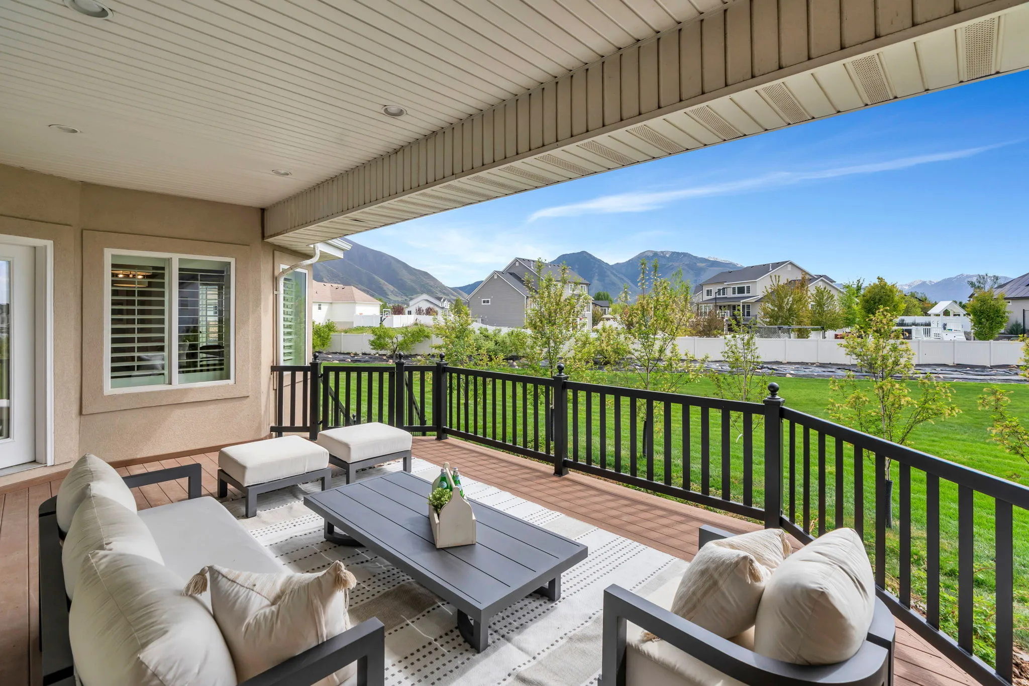Wooden terrace with an outdoor lounge area, a mountain view, and a residential view