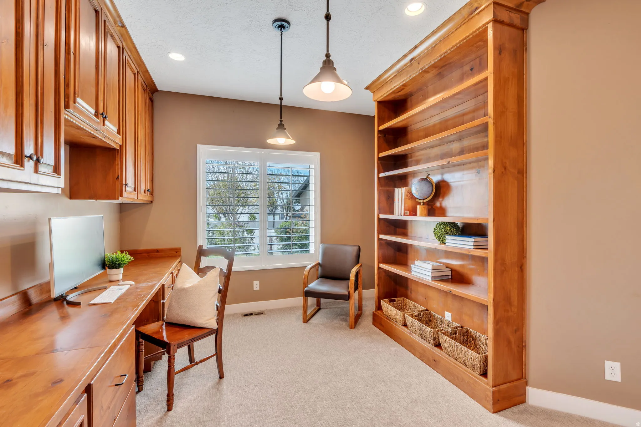 Home office featuring light colored carpet, recessed lighting, and a textured ceiling