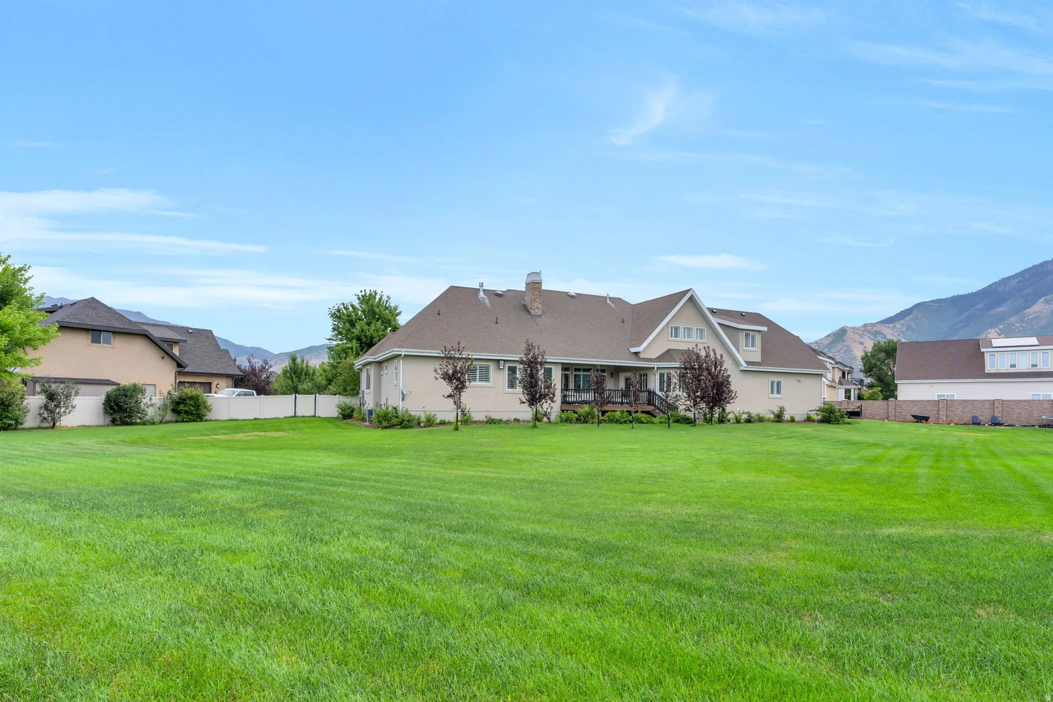 Expansive green lawn with mountain backdrop