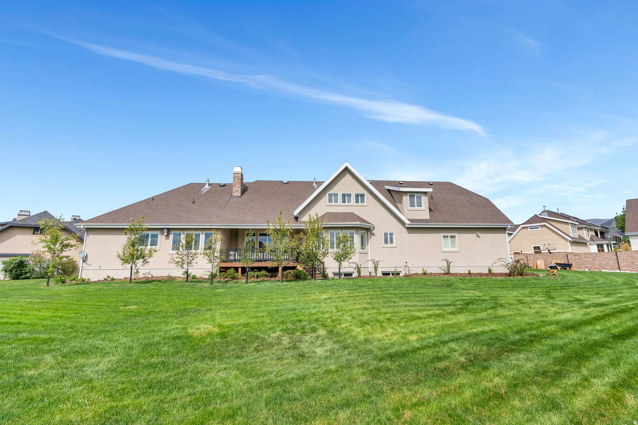 Rear view of property with a deck and a chimney