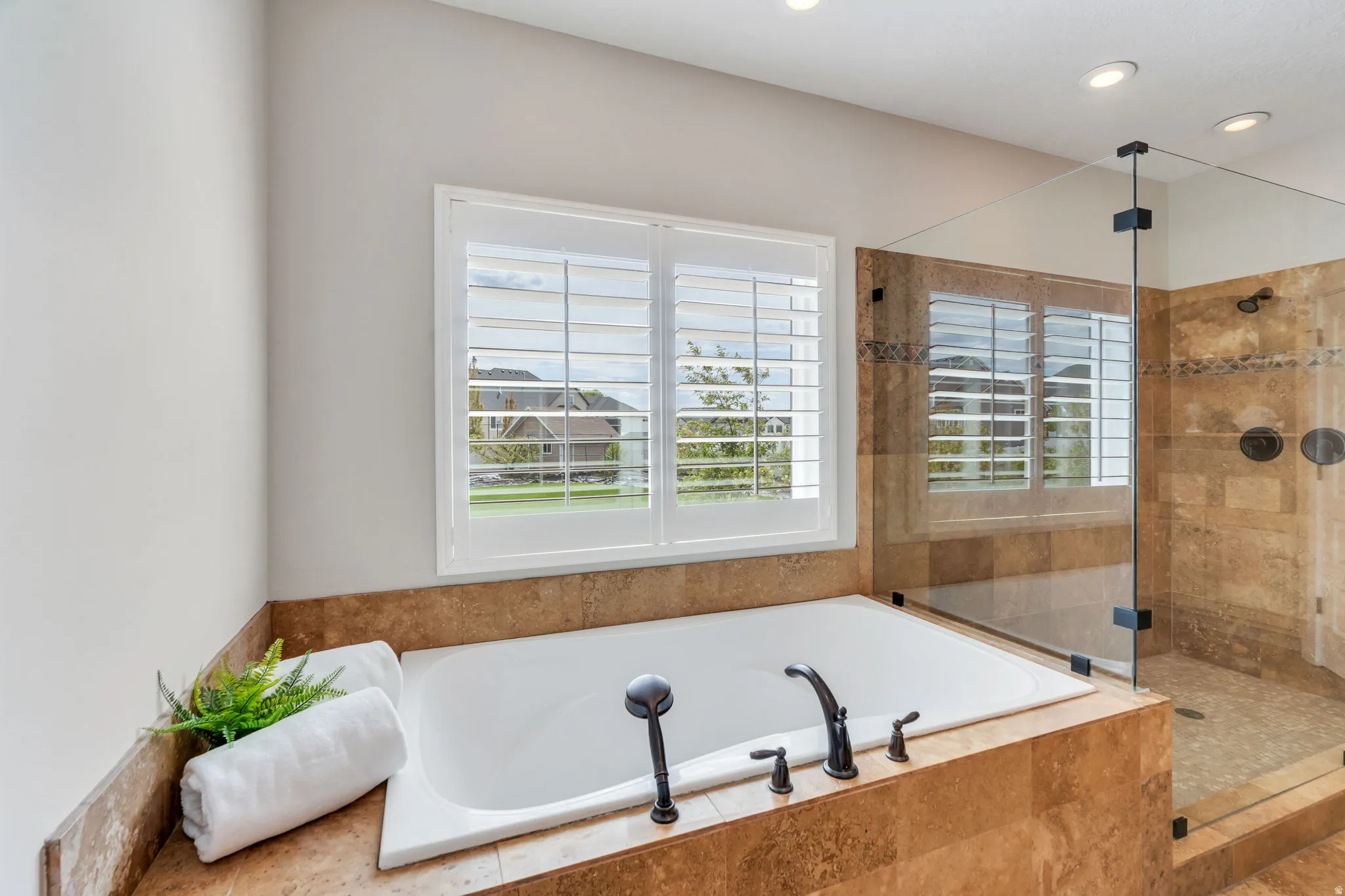 Full bathroom featuring a shower stall and a bath