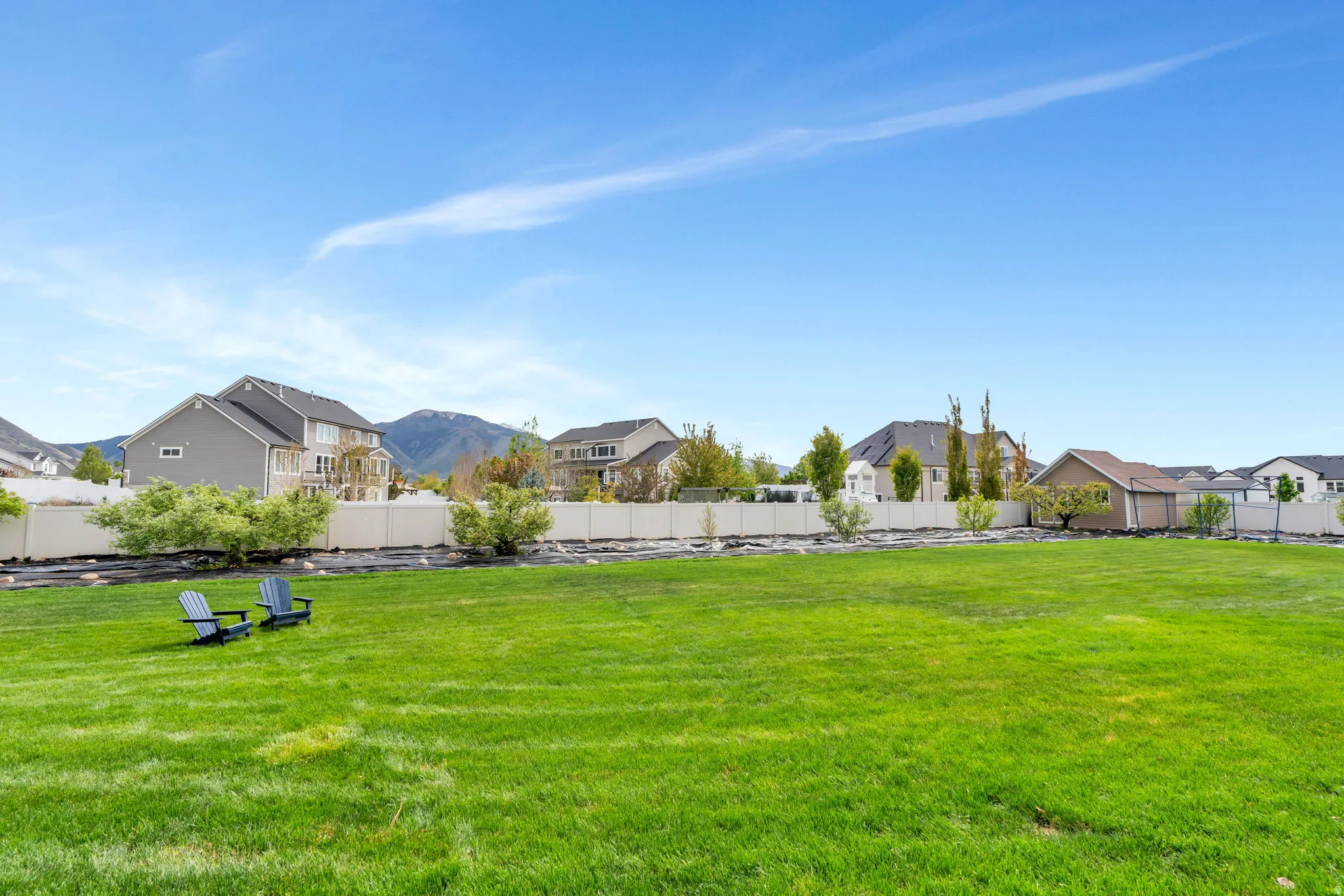Fenced backyard featuring a residential view and a mountain view
