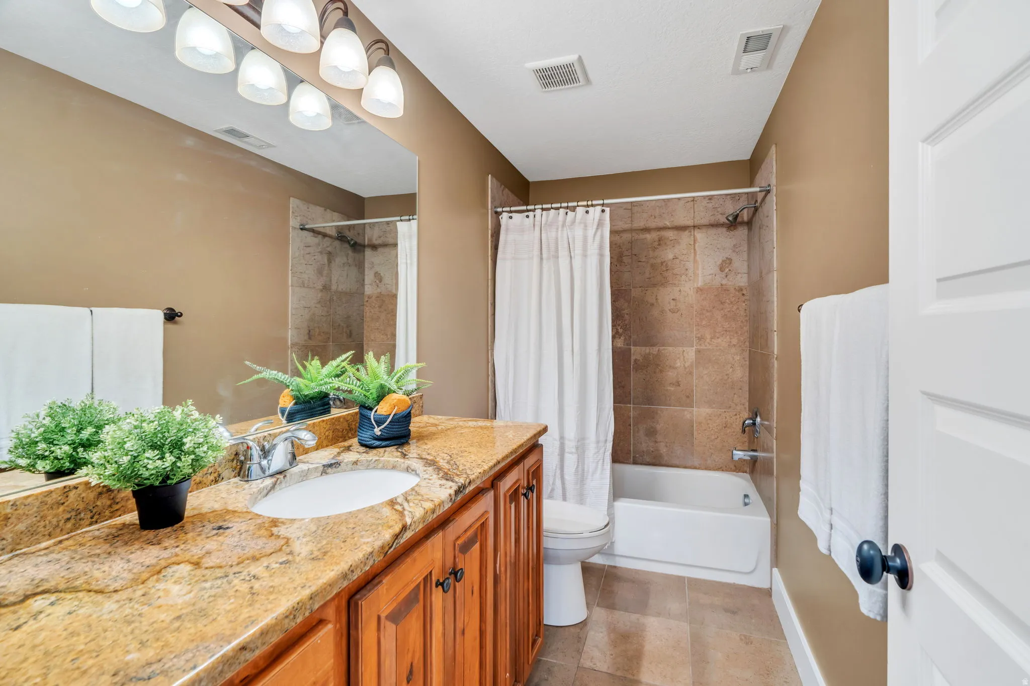 Bathroom featuring vanity and shower / tub combo with curtain