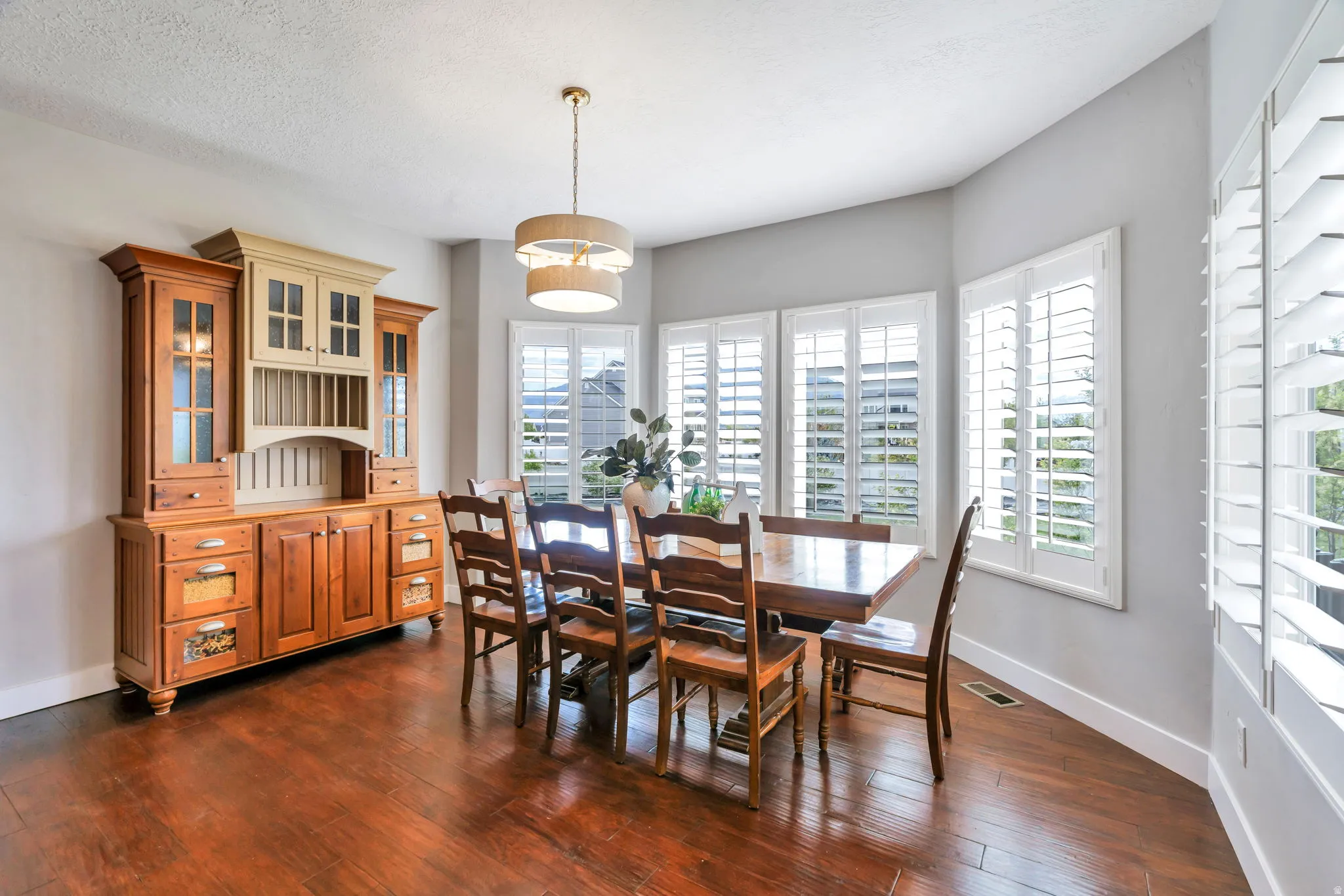 Dining space with dark wood finished floors