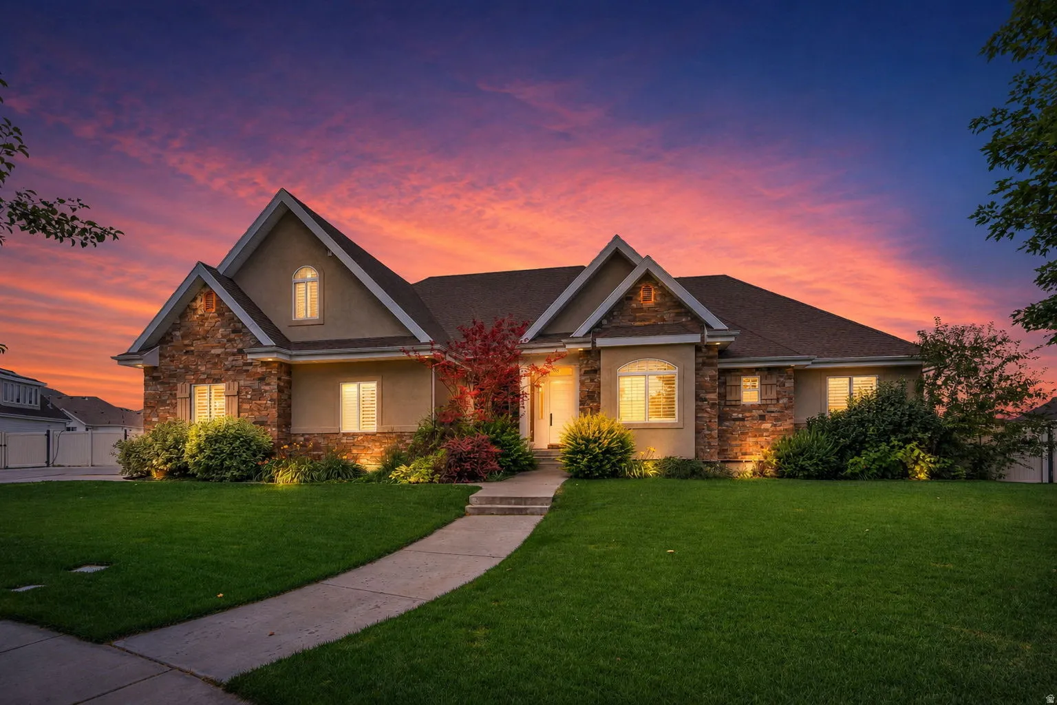 Striking exterior featuring stone accents, stucco siding, and a gabled roofline