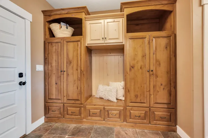 Built-in wood-finish cabinetry featuring storage compartments, drawers, and an integrated bench seating area