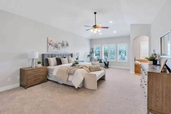 Spacious room featuring vaulted ceilings, recessed lighting, and a ceiling fan