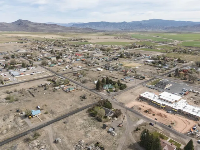 Overview of rural landscape featuring mountains and nearby suburban area